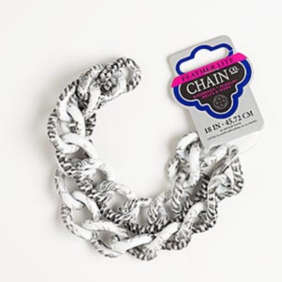 Picture of Chain, aluminum, black and white, 32x23mm twisted oval cable with checker pattern. Sold per pkg of 18 inches.